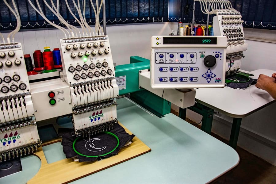 Logo being embroidered on a garment